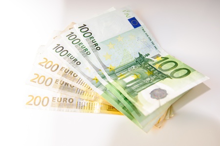 Euros, hundred, two hundred and coins on a white tableの写真素材