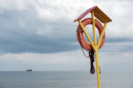 Lifebuoy on the beach with a dark blue skyの写真素材