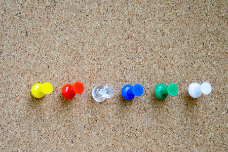 Closeup of colorful pushpin on cork board.の写真素材