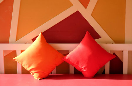 Colorful backrest pillow  on the red sofa-bed.