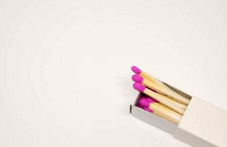 Box of pink match in closeup with white background.