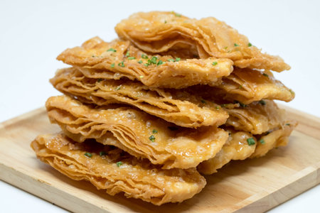 Crispy roti bread is Thai dessert on wooden plate.
