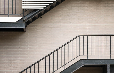 Black metal staircase  beside modern office building.の写真素材