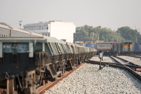 Light sign among train  tracks iwith blurred train car in background.