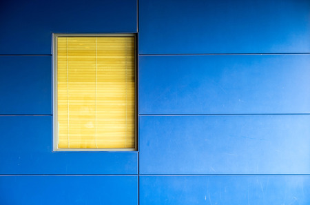 Wooden curtain behind glass window and blue wall of modern office.の写真素材