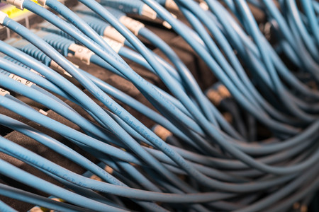 Ethernet cable on network switches in background.の写真素材