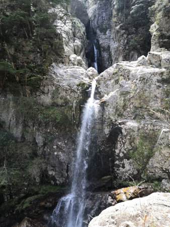 A large waterfall deep in the mountains of Japan.の写真素材