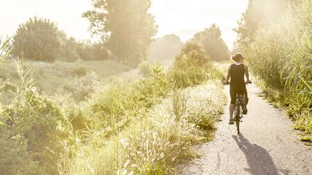 Woman on bike outdoor in summerの写真素材