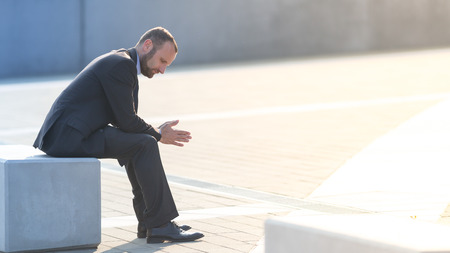Unhappy and depressed businessman outdoor in the cityの写真素材