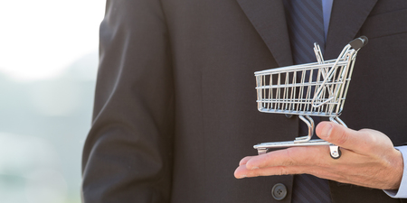 Businessman holding a shopping cartの写真素材