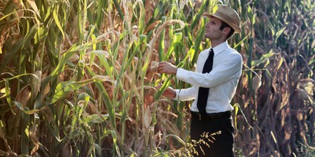 Business and farmer checking his products