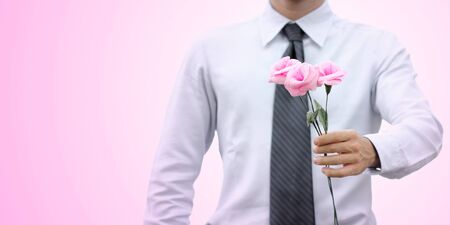 Romantic businessman giving a roseの写真素材