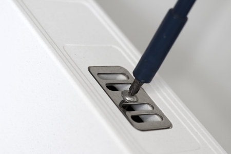 Repairman fixing a kitchen sink, construction and architecture concepts