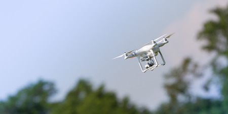 Flying drone in action; photographed on a defocused background. Royalty free image, no logos in the photo.の写真素材