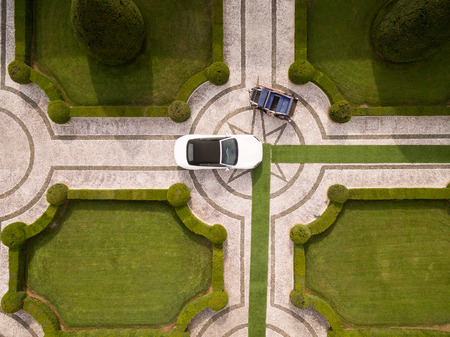 Sport car in a formal geometric garden, aerial shot made with a droneの写真素材