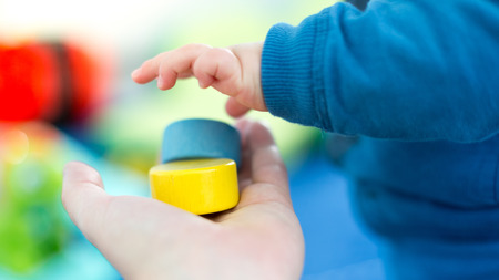Cute and happy baby playing with his toysの写真素材