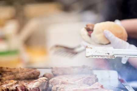 Cooking pork sausages in a street marketの写真素材