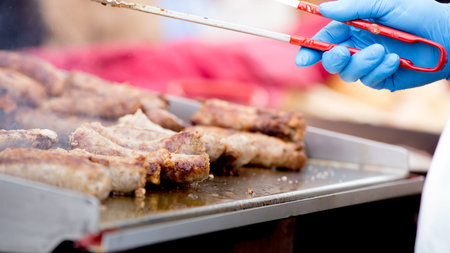 Cooking pork sausages in a street marketの写真素材