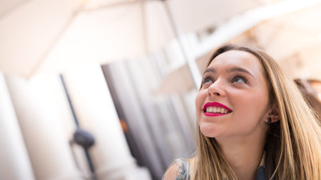 Beautiful teenager girl looking up, close up photo with defocused copy space backgroundの写真素材