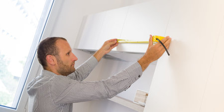 Architect taking measures of a brand new kitchen. Home style and design conceptsの写真素材