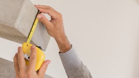 Architect taking measures of a concrete steps staircase. Home style and design conceptsの写真素材