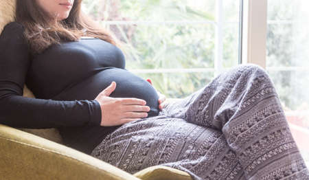 Pregnant woman, family, love and life concepts. Horizontal wide photo with copy space.の写真素材