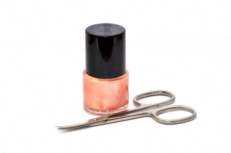 Nail polish with nail scissors isolated on whiteの写真素材