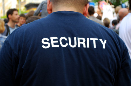 security guard in front of a crowd of people