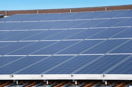 solar panels on a roof with blue skyの写真素材