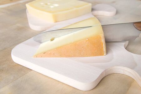 bavarian cheese with knife on a cutting boardの写真素材