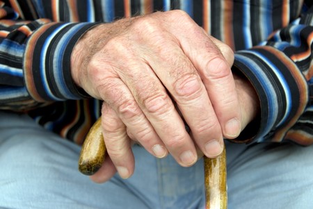 hand of a senior man holding a cane hand of a senior man holding a cane