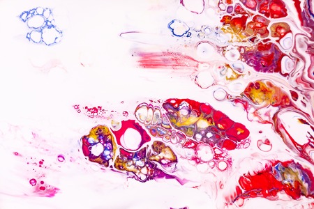 Mixture of acrylic paints. Modern artwork with spots and splashes of color paint. Liquid marble texture. Applicable for design packaging, labels, business cards, and interactive web backgrounds.の写真素材