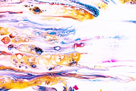 Mixture of acrylic paints. Modern artwork with spots and splashes of color paint. Liquid marble texture. Applicable for design packaging, labels, business cards, and interactive web backgroundsの写真素材