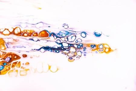 Mixture of acrylic paints. Modern artwork with spots and splashes of color paint. Liquid marble texture. Applicable for design packaging, labels, business cards, and interactive web backgroundsの写真素材