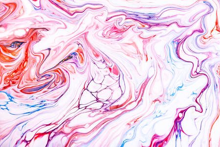 Mixture of acrylic paints. Modern artwork with spots and splashes of color paint. Liquid marble texture. Applicable for design packaging, labels, business cards, and interactive web backgroundsの写真素材