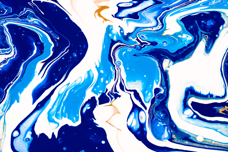 Hand painted background with mixed liquid blue, white, yellow paints. Abstract fluid acrylic painting. Applicable for packaging, invitation, textile, wallpaper, design of different surfacesの写真素材
