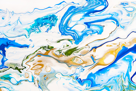 Hand painted background with mixed liquid blue, white, yellow paints. Abstract fluid acrylic painting. Applicable for packaging, invitation, textile, wallpaper, design of different surfacesの写真素材
