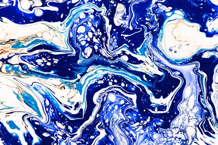 Hand painted background with mixed liquid blue, white, yellow paints. Abstract fluid acrylic painting. Applicable for packaging, invitation, textile, wallpaper, design of different surfacesの写真素材