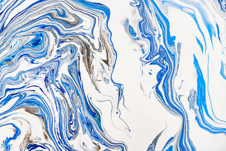 Hand painted background with mixed liquid blue, white, yellow paints. Abstract fluid acrylic painting. Applicable for packaging, invitation, textile, wallpaper, design of different surfacesの写真素材
