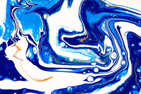 Hand painted background with mixed liquid blue, white, yellow paints. Abstract fluid acrylic painting. Applicable for packaging, invitation, textile, wallpaper, design of different surfacesの写真素材