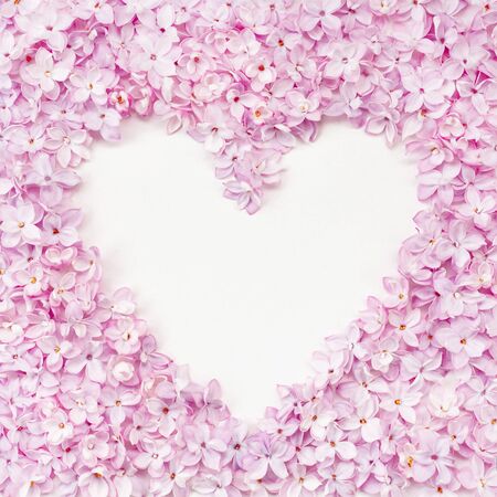 Lilac flowerheads heart shape frame. Floral beautiful border with copyspace. Springtime blossoming background. Summer, spring holiday greeting card, postcard, wedding invitationの写真素材