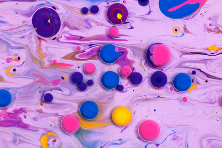 Acrylic paint balls abstract texture. Purple, blue, pink and yellow liquids mix. Creative multicolor...