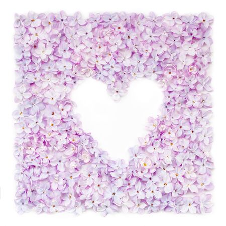 Lilac flowerheads heart shape frame. Floral beautiful border with copyspace. Springtime blossoming background. Summer, spring holiday greeting card, postcard, wedding invitationの写真素材