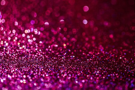 Pink glitter raster festive background. Abstract violet blurred circles. Bokeh lights with bright shiny effect illustration. Overlapping glowing and twinkling spots decorative backdrop designの写真素材