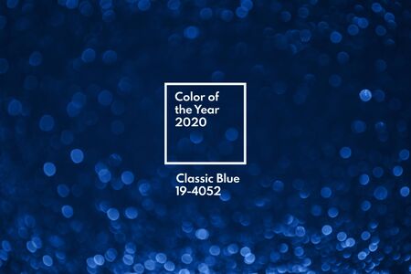 Classic blue color of the year 2020. Bokeh lights with bright shiny effect illustration. Overlapping glowing and twinkling spots decorative backdrop. Abstract glittering circlesの写真素材