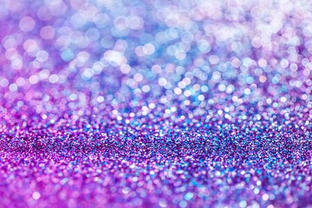 Purple glitter raster festive background. Abstract violet blurred circles. Bokeh lights with bright shiny effect illustration. Overlapping glowing and twinkling spots decorative backdrop designの写真素材