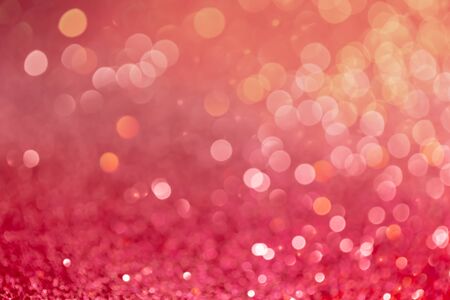 Decoration twinkle lights background, abstract glowing backdrop with circles,modern design overlay with sparkling glimmers. Red, pink and golden backdrop glittering sparks with blur effectの写真素材