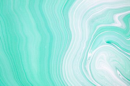 Fluid art texture. Backdrop with abstract swirling paint effect. Liquid acrylic picture that flows and splashes. Mixed paints for baner or wallpaper. Mint and white overflowing colorsの写真素材