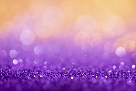 Decoration twinkle lights background, abstract shiny backdrop with circles,modern design overlay with sparkling glimmers. Purple and golden backdrop glittering sparks with glow effectの写真素材