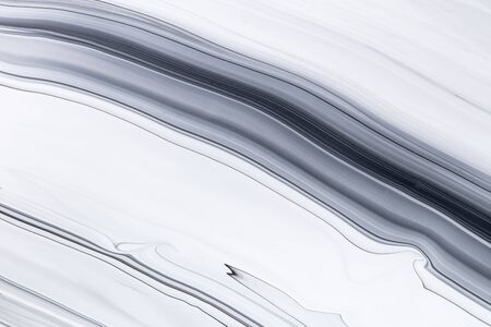 Fluid art texture. Backdrop with abstract mixing paint effect. Liquid acrylic picture with flows and splashes. Mixed paints for background or poster. Black and white overflowing colorsの写真素材